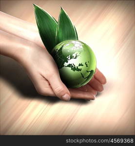 human hands holding green earth with a growing plant