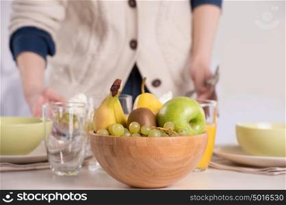 Human hands preparing table for lunch