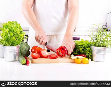 human hands preparing vegetables on the board in the kitchen