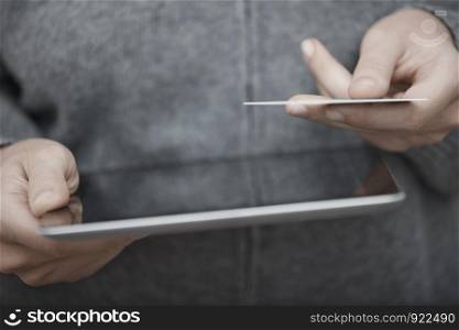 Human hands with tablet PC and credit card