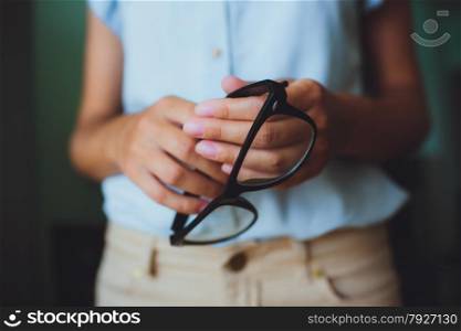 Human hands woman holding eyeglasses. Human hands woman holding retro style eyeglasses