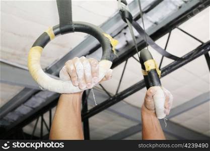 Human hanging in Gymnastic Rings. Focus on the right hand.