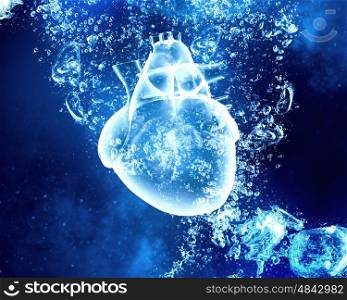 Human heart under water. Human heart in clear blue crystal water