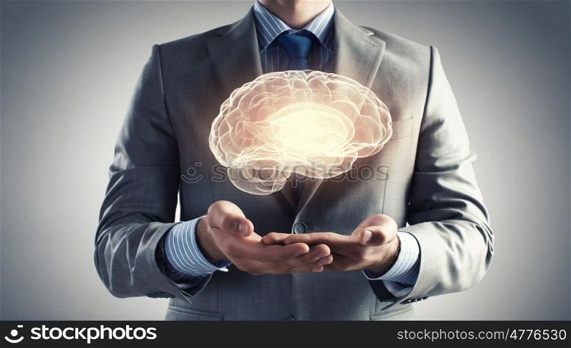 Human mind. Close up of businessman holding digital image of brain in palm