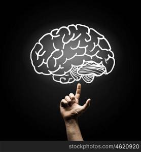 Human mind. Human hand pointing with finger at brain icon