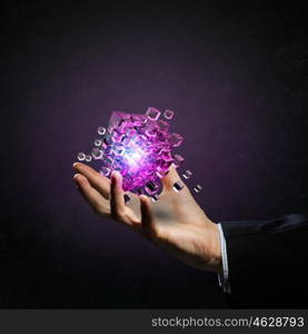 Human Resources concept. Businessman close view holding in hand magic glowing cube