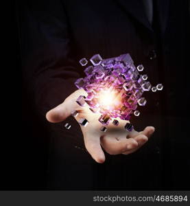 Human Resources concept. Businessman close view holding in hand magic glowing cube