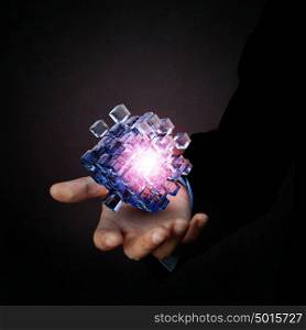 Human Resources concept. Businessman close view holding in hand magic glowing cube