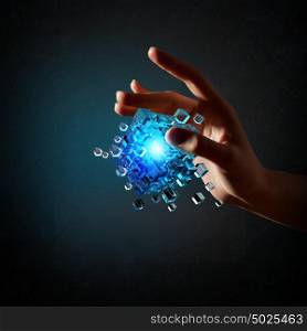 Human Resources concept. Person hand taking with fingers magic glowing cube