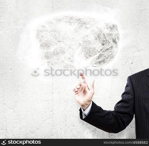 Human strength and power. Businessman in suit pointing at huge stone