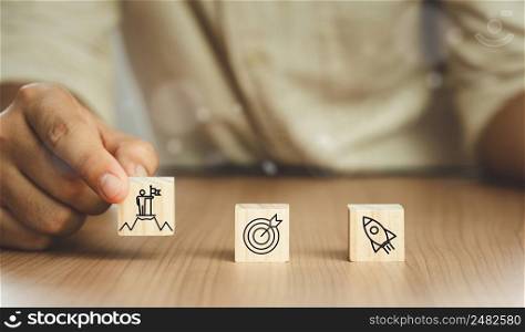 Human touch goals achievement icon on wood box of darts aiming at the target. business management  goal strategy and action plan. Global customer network connection  on virtual interface. Start up.