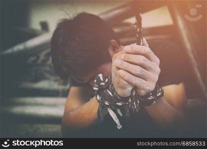 human trafficking, hands tied together with rope