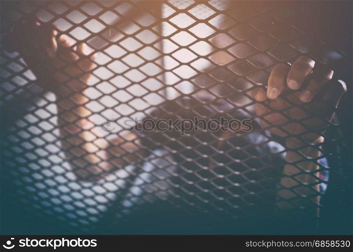human trafficking, man in cage with orange light