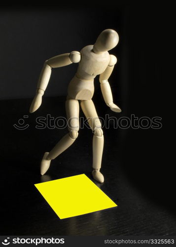 humanoid with a yellow sign on the floor by his feet