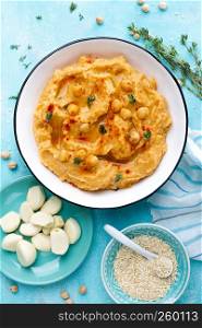 Hummus with chickpea and tahini, delicious and healthy protein vegan and vegetarian food, top view, flat lay