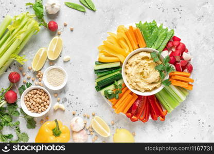 Hummus with fresh vegetables, healthy vegetarian food concept, top view