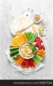Hummus with fresh vegetables, healthy vegetarian food concept, top view