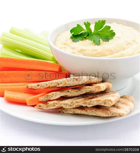 Hummus with pita bread and vegetables