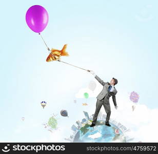 Humorous guy with balloons. Funny man in suit with bunch of colorful balloons in hand