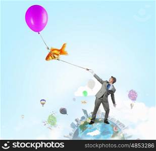 Humorous guy with balloons. Funny man in suit with bunch of colorful balloons in hand