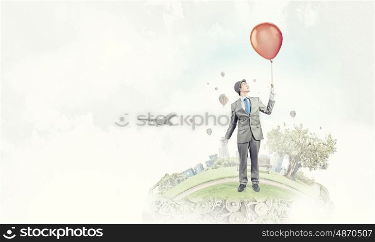 Humorous guy with balloons. Funny man in suit with bunch of colorful balloons in hand
