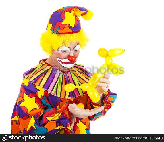 Humorous picture of a clown looking disgusted as a balloon animal poops in his hand.
