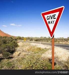 Humorous road sign reading Give Way in rural Australia.