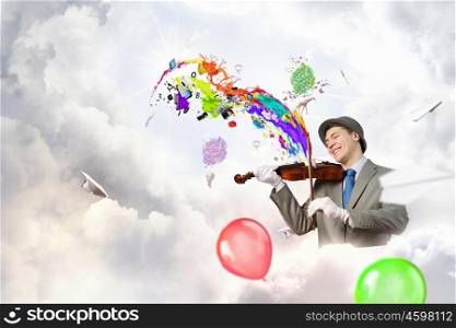 Humorous violin performer. Funny violin clown player in suit hat and white gloves