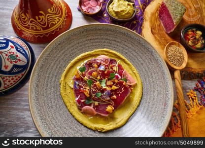Humus with marinated tuna Moroccan recipe on wooden table