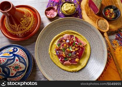 Humus with marinated tuna Moroccan recipe on wooden table