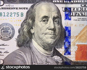 hundred dollar bank note with image of president Benjamin Franklin