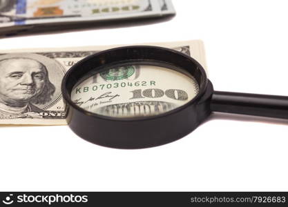 Hundred dollar banknote under magnifying glass