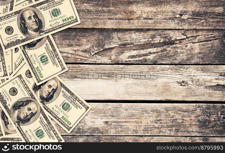 hundred dollar bills on wood table