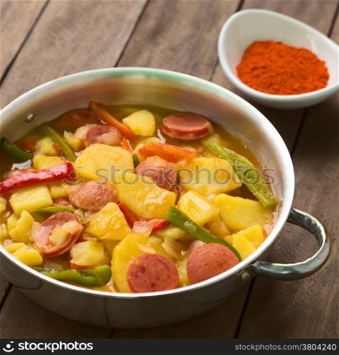 Hungarian dish called Paprikas Krumpli (Potato with Paprika), a stew made of potato, onion, pepper, tomato and sausage, seasoned with the Hungarian paprika and salt (Selective Focus, Focus in the middle of the dish)