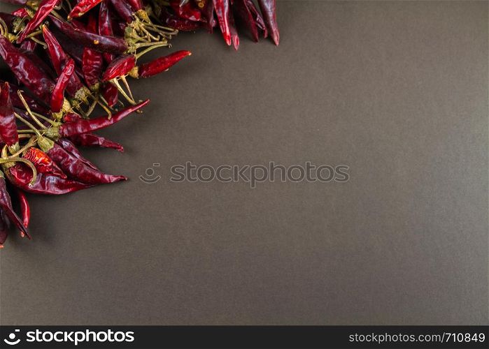 Hungarian paprika pepper string, grey background, copy space on right, landscape, closeup
