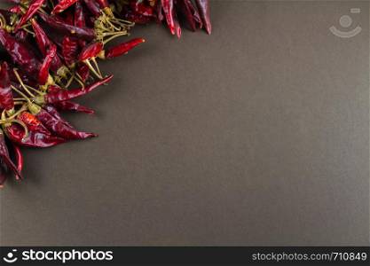Hungarian paprika pepper string, grey background, copy space on right, landscape, closeup