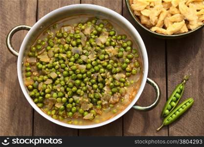 Hungarian pea stew made of onion and peas and seasoned with paprika and salt, served usually with Hungarian galuska or nokedli (homemade noodles) (Selective Focus, Focus on the middle and lower part of the stew)