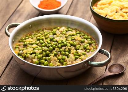 Hungarian pea stew made of onion and peas and seasoned with paprika and salt, served usually with Hungarian galuska or nokedli (homemade noodles) (Selective Focus, Focus into the middle of the stew)