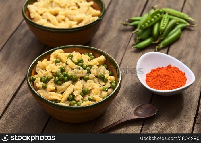 Hungarian vegetarian pea stew seasoned with paprika served with homemade noodles called Nokedli or Galuska in rustic bowl (Selective Focus, Focus on the middle of the dish)