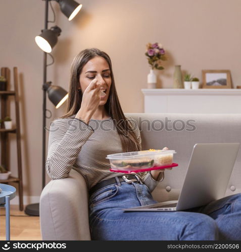 hungry businesswoman eating sitting sofa