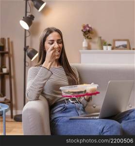 hungry businesswoman eating sitting sofa