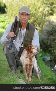 Hunter kneeling by dog