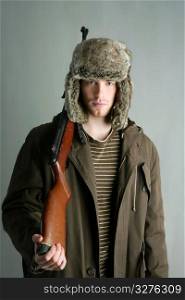 Hunter man fur winter hat holding rifle gun brown autumn coat