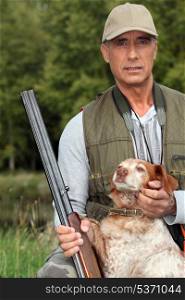 Hunter with a shotgun and dog