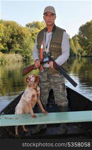 Hunter with dog on boat