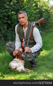 Hunter with shotgun and spaniel