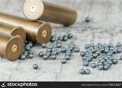 Hunting cartridges and lead shot on the old wooden boards