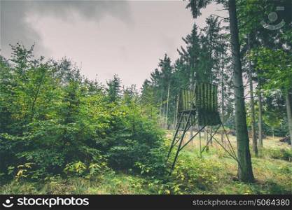 Hunting tower in green camoflage in a forest
