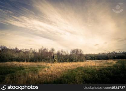 Hunting tower on a field in autumn scenery