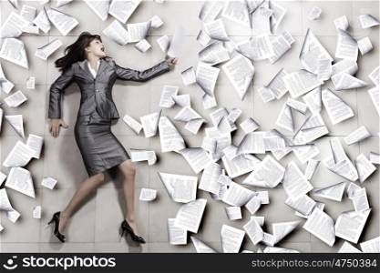 Hurrying businesswoman. Attractive businesswoman running with papers in hand